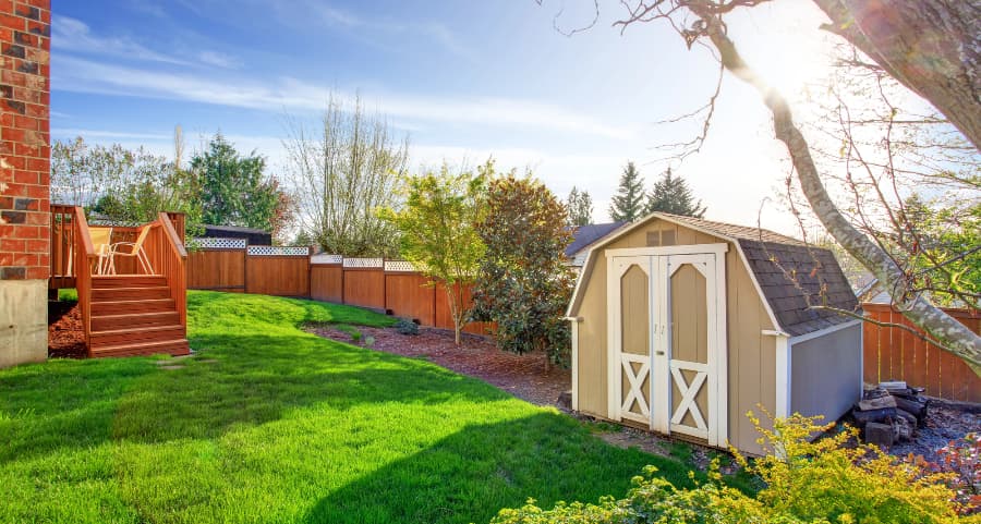 Fenced backyard with storage shed in State College